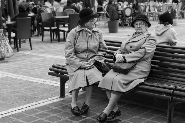 Romanian ladies sitting on a bench | Wall Art Online now