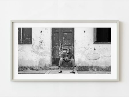 Young man sitting on a doorstep in rural Cuba | Wall Art Hot on Sale