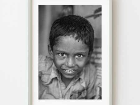 Young boy staring straight into the camera in Southern India | Wall Art on Sale